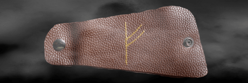 Fehu rune on the skin as a lucky charm